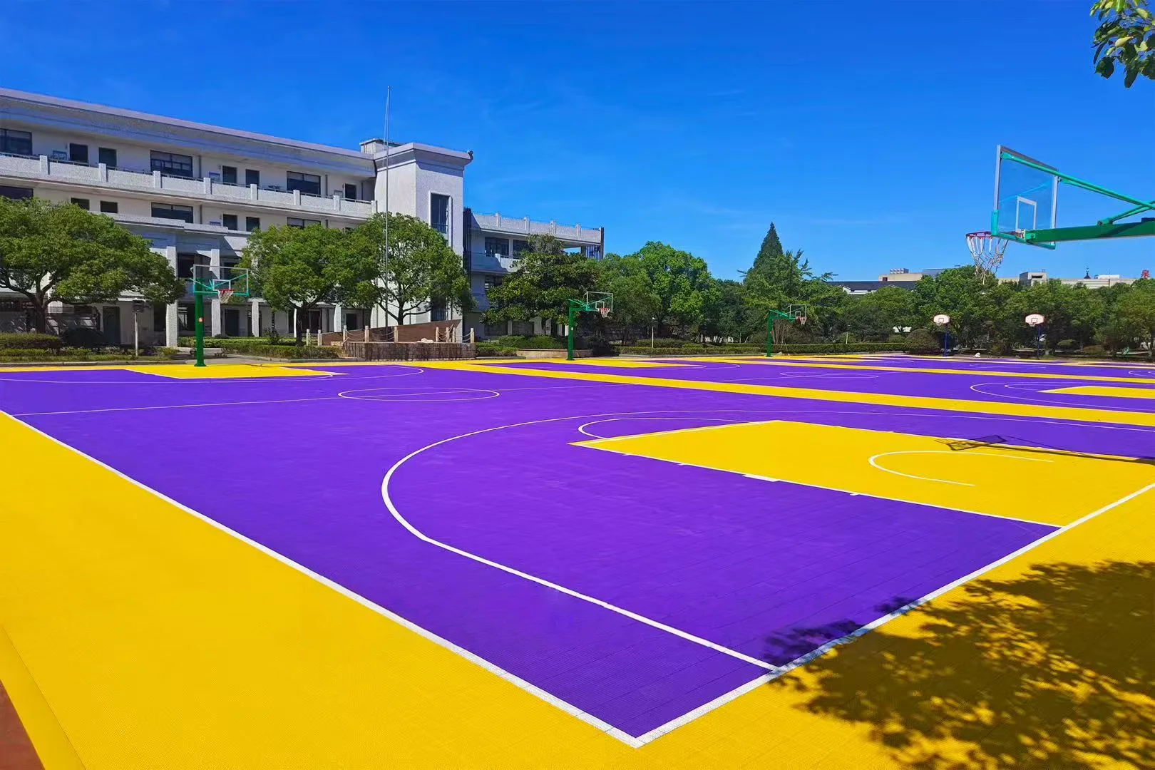 Outdoor basketball court with purple and gold surfacing